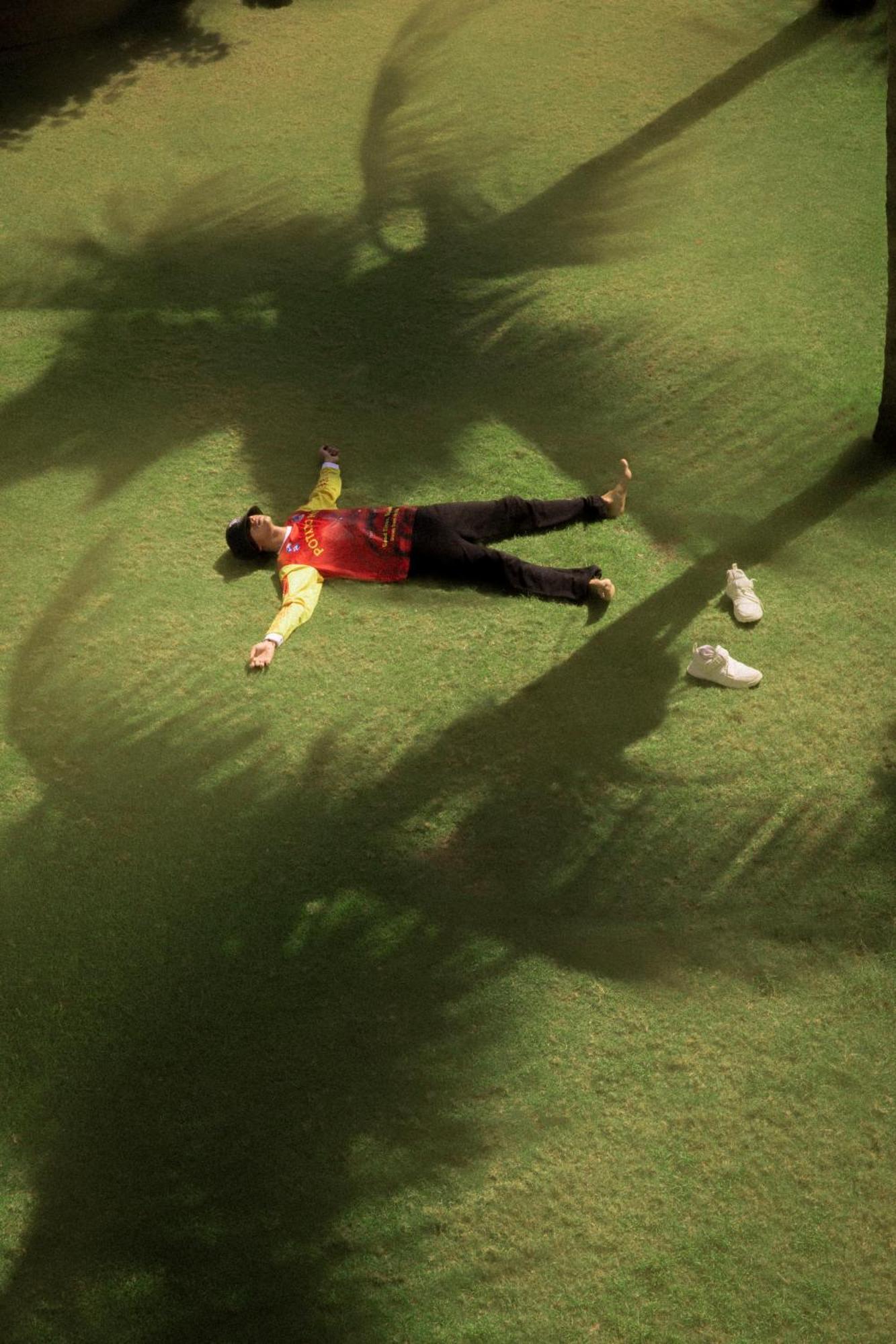 Potato Head Suites & Studios Seminyak  Exterior photo A man lying on the grass